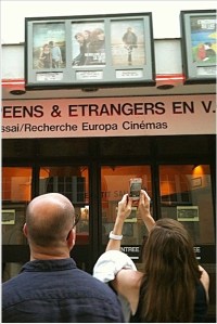 Melinda, flanked by Bernard, taking a picture outside the theatre.