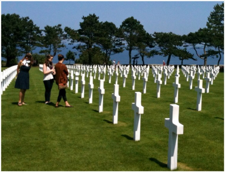 Melinda, Ella & Chloe* at the American Cemetery at Omaha Beach, 22 July, 2014. In the distance is the English Channel and below the tree line and down a steep embankment is Omaha Beach.