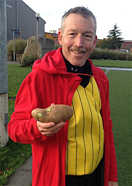 That's my brother, Scott, in this photo. Years ago, he told his eldest daughter that November 1st was National Potato Day. Coming on the day after Halloween, neighbors are warmed up to the idea of people knocking on their doors and expecting something to eat. So you knock and when your neighbor answers, you say in a demanding voice, "Gimme a potato!" With Scott refereeing Celeste's game this afternoon, I made sure to have a potato with me.