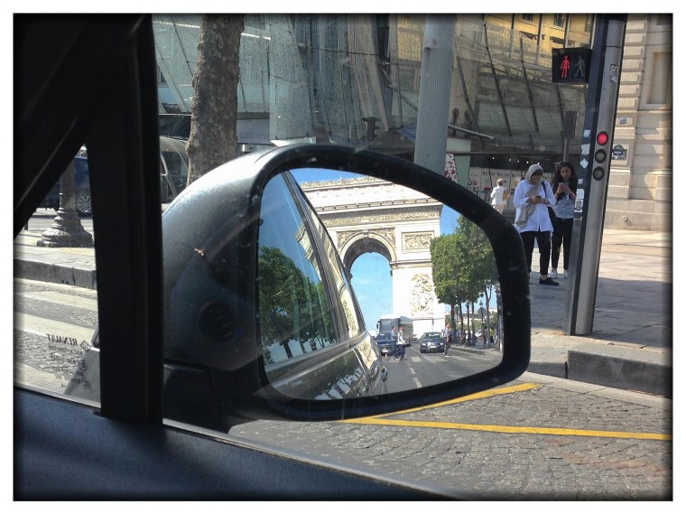 To prove we came by car to Paris, I offer this photo that I took out the passenger side window of the side mirror.  Yes, that's the Arc de Triomphe. Yes, we are driving on the Champs-Elysees. 