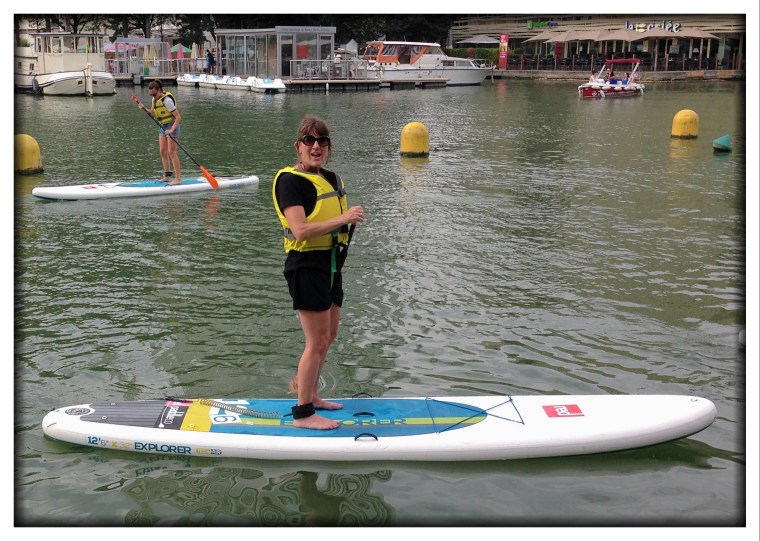 You decide if this is surprising or not. Melinda discovered a place that let her check out a paddle board for free. So there she is, in a dress, on a paddle board in Paris. She even talked Christine, Bernard, and Celeste to go with her. In fact, that's Celeste in the background in the upper left. 